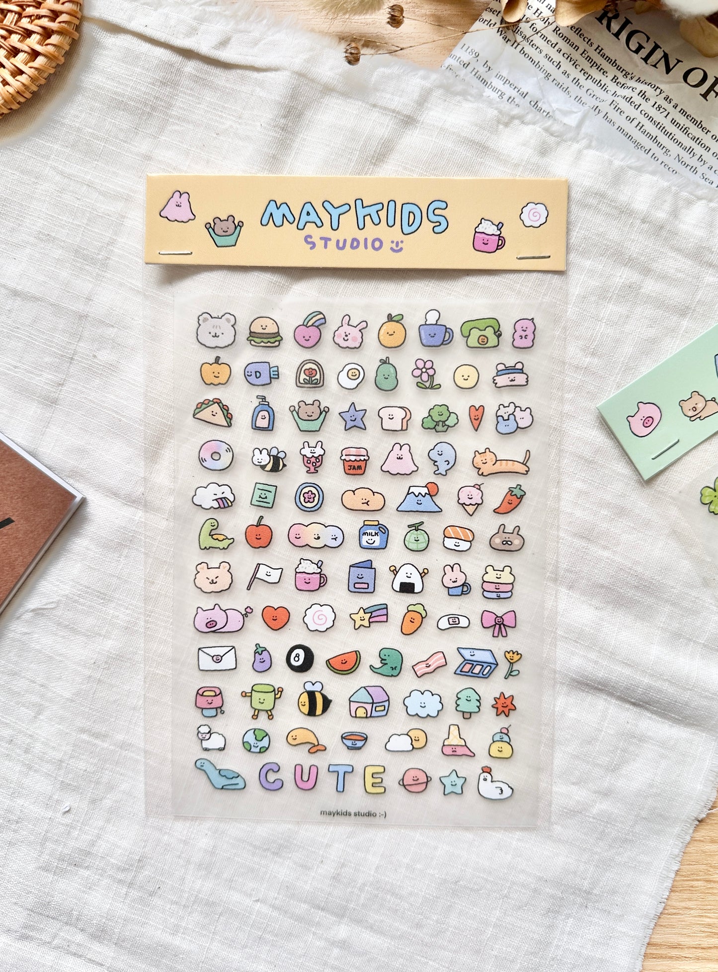 Sheet of colorful stickers with 'MAYKIDS STUDIO' branding on a textured surface. cute, sticker, hope and letters, nz, auckland,