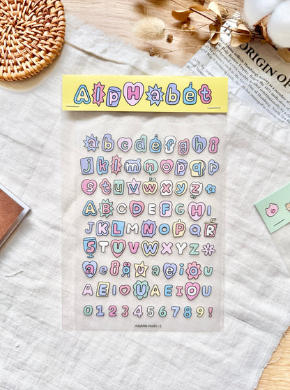 Pack of colorful alphabet and number stickers on a textured surface with decorative items. cute, sticker, pastel, hope and letters, stationery, nz
