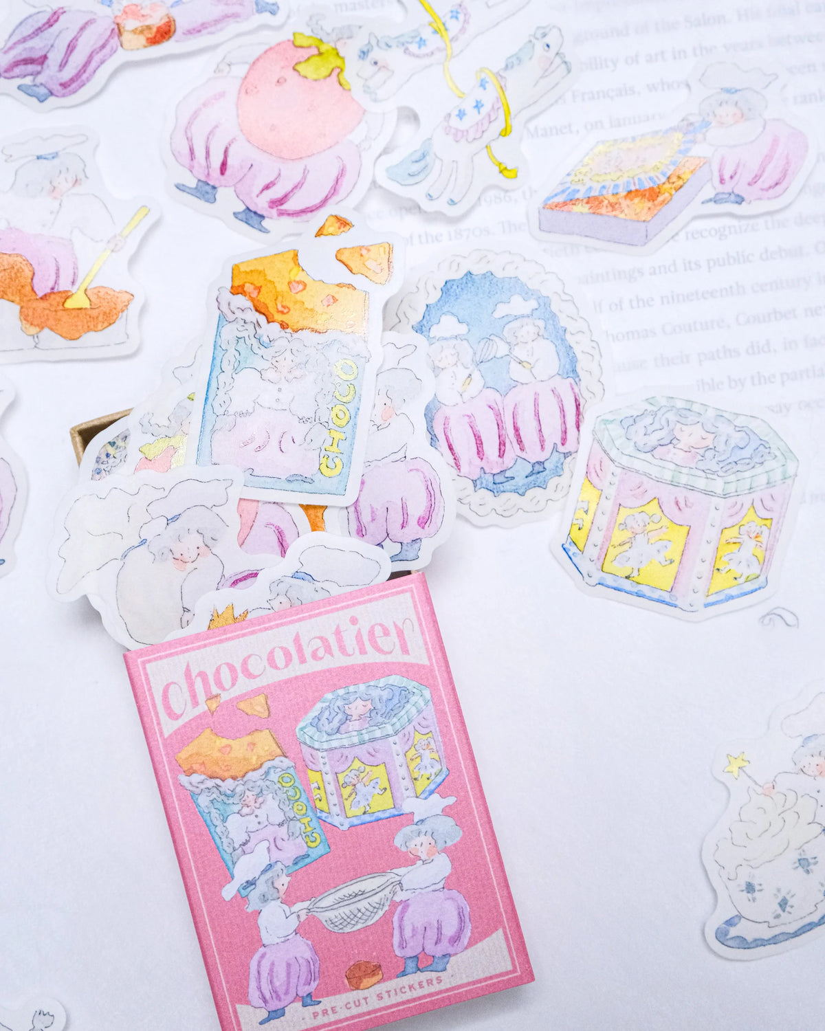 Sticker sheet with pastel-colored desserts and a pink 'Chocolatier' box on a light background, sticker flakes, matchbox, dodolulu, cute, pink, chocolate, nz, hope and letters, new zealand, stationery,
