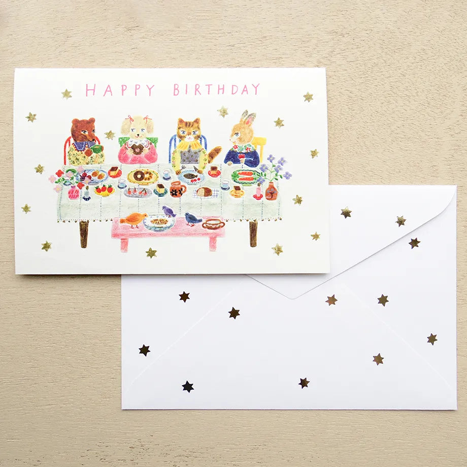Birthday card with animal illustrations on a table with a pen and flowers. cute, birthday card, cat, flowers, floral, nz, hope and letters, nz, auckland, new zealand, stationery, party, food,