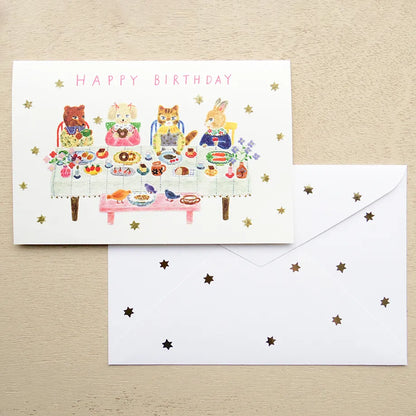 Birthday card with animal illustrations on a table with a pen and flowers. cute, birthday card, cat, flowers, floral, nz, hope and letters, nz, auckland, new zealand, stationery, party, food,