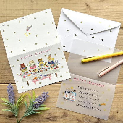 Birthday card with cat illustrations on a table with a pen and flowers. cute, birthday card, cat, flowers, floral, nz, hope and letters, nz, auckland, new zealand, stationery,