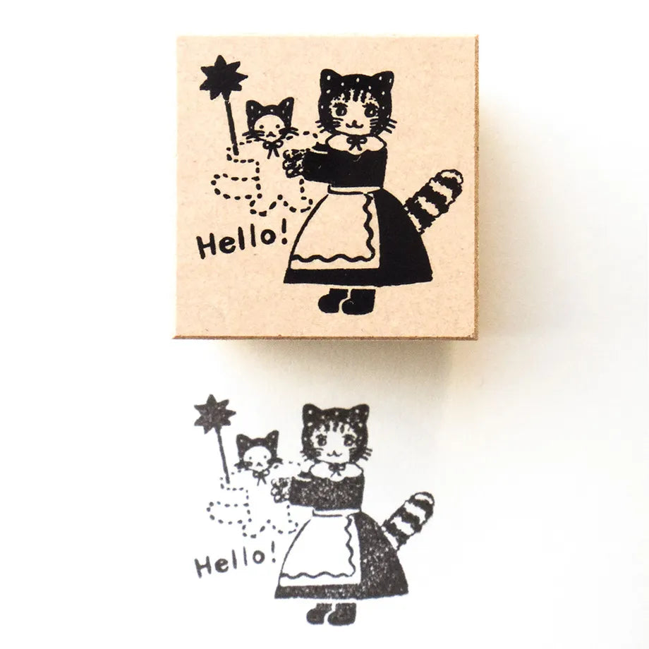 A wooden rubber stamp and its printed impression, featuring a retro-style illustration of a cat in a maid outfit holding a star wand with the word 'Hello!' on a white background.