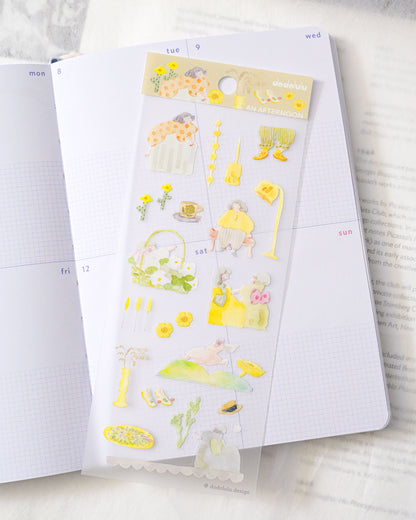 A sheet of cute yellow and pastel planner stickers displayed on an open white grid notebook, with more pages visible in the background. dodolulu, hope and letters, cute, yellow, sticker