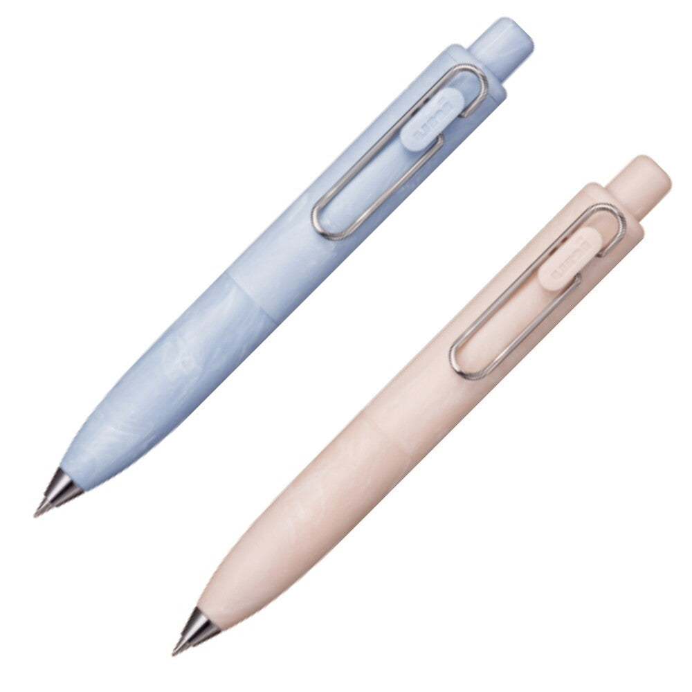 Two retractable ballpoint pens on a plain white background, one in light blue and one in pale pink, both with silver metal clip details. uni, pen, ball point, gel pen, nz, hope and letters, pastel, bath bomb