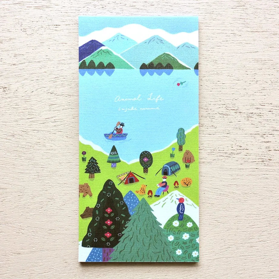 Notebook with a colorful illustration of a scenic landscape on a wooden surface, memopad, animal, camping, notepad, nz, hope and letters, cute, japan, mountain, ocean, kayak