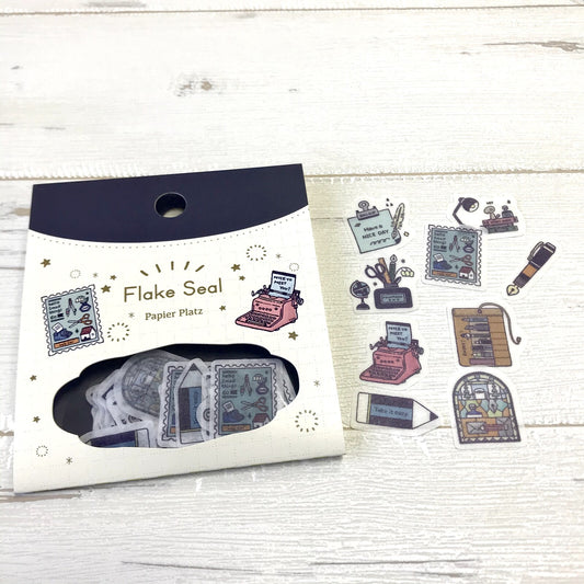 Packaging of Flake Seal stickers with typewriter design on a wooden surface, cute, japan, stickers, flake seal, eric small things, hope and letters, nz, journal, pen, pencil, 