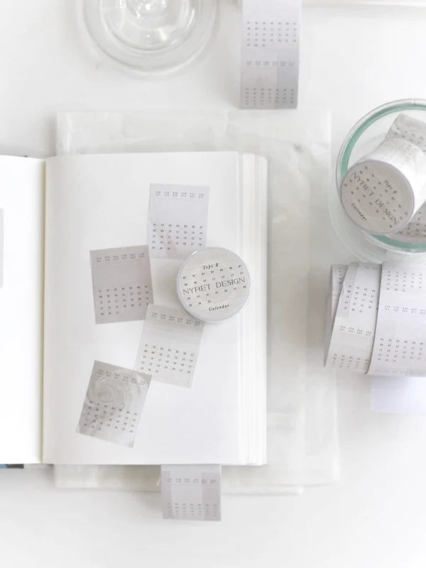 White product packaging with a calendar tape, label on a white background, calendar, tape, hope and letters, minimalist, date, month, sticker