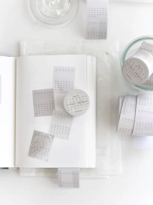 White product packaging with a calendar tape, label on a white background, calendar, tape, hope and letters, minimalist, date, month, sticker